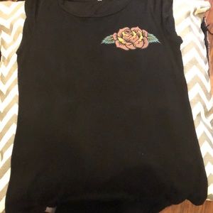 A black top with a floral skull design on the back